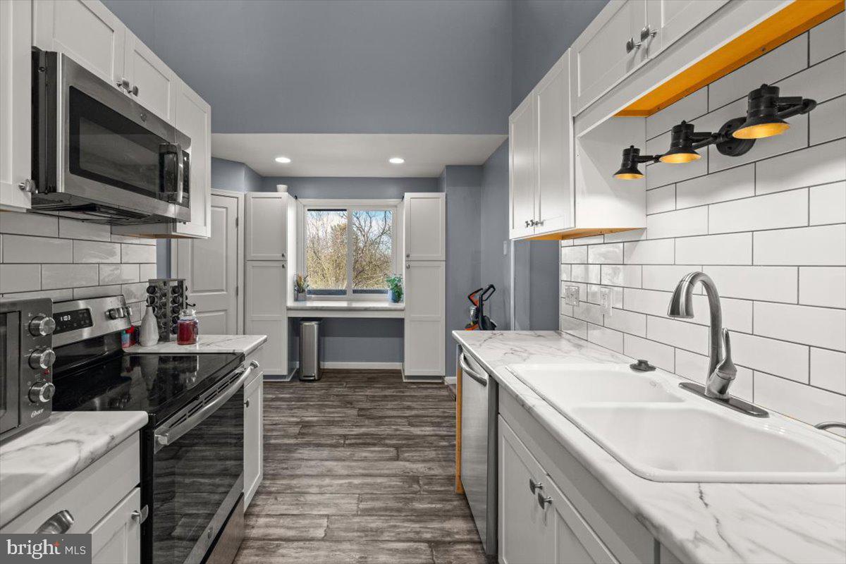107 Gloucester Road Front Royal, VA 22630 - Photo 7 of 22 a kitchen that has a sink and a stove in it