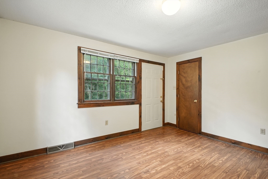 167 Warren Wright Road Belchertown, MA 01007 - Photo 15 of 42 a view of an empty room with wooden floor and a window