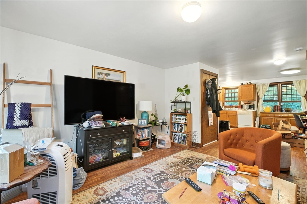 167 Warren Wright Road Belchertown, MA 01007 - Photo 22 of 42 a living room with furniture and a flat screen tv
