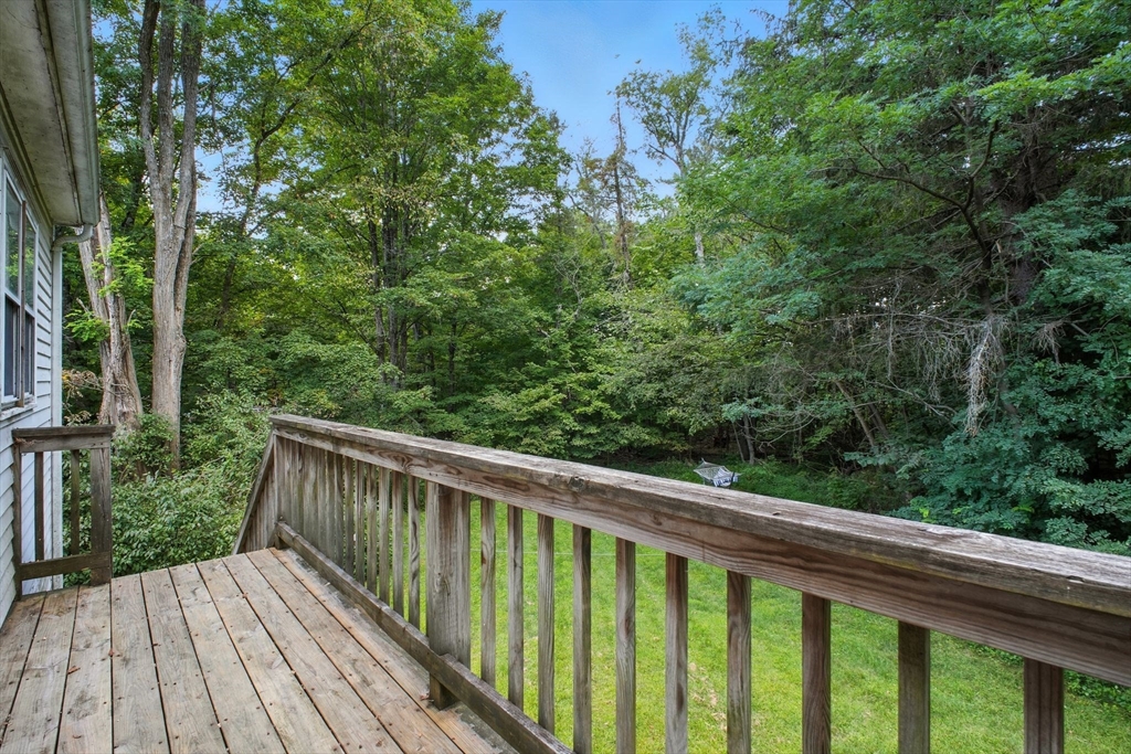 167 Warren Wright Road Belchertown, MA 01007 - Photo 31 of 42 a balcony with wooden floor and yard in the back