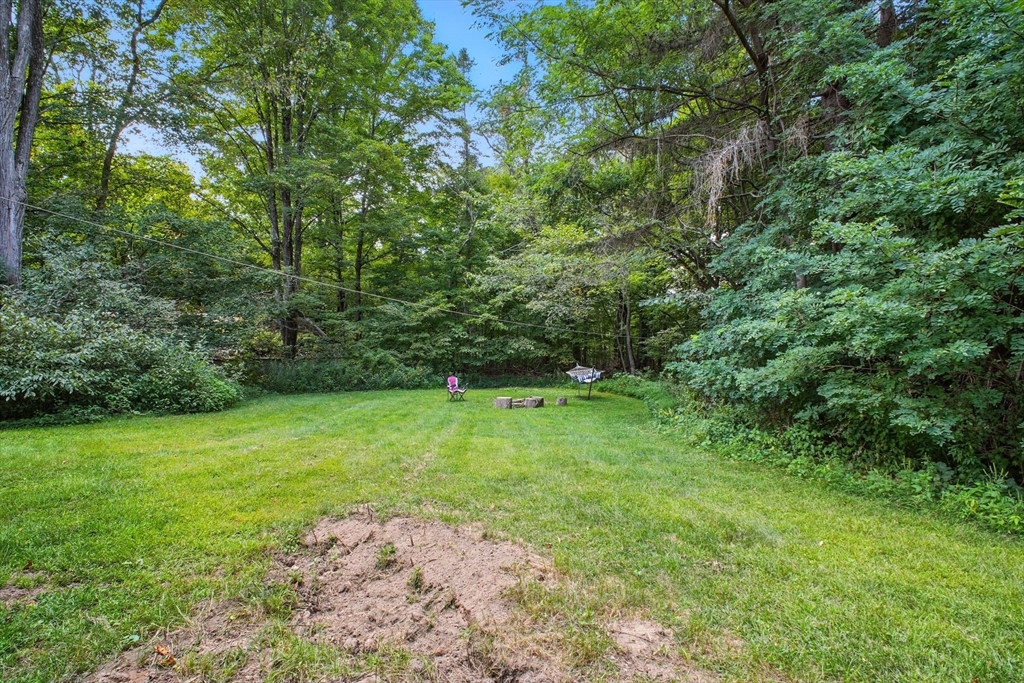 167 Warren Wright Road Belchertown, MA 01007 - Photo 42 of 42 a green field with lots of trees in it