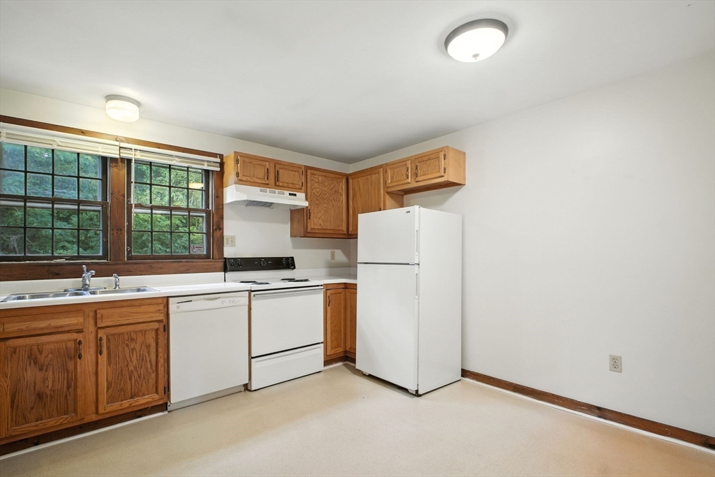 167 Warren Wright Road Belchertown, MA 01007 - Photo 9 of 42 a kitchen with a refrigerator and a sink