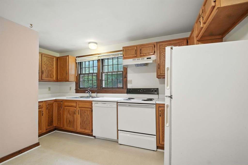 167 Warren Wright Road Belchertown, MA 01007 - Photo 10 of 42 a kitchen with a sink cabinets and window
