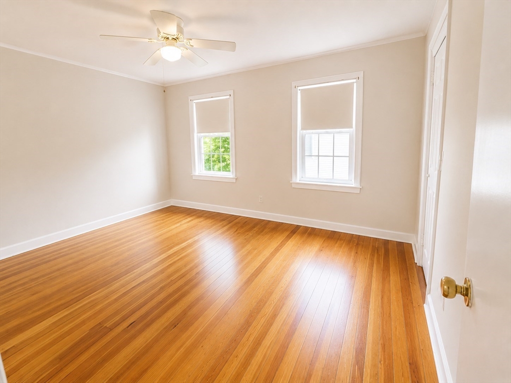 36 Plummer Avenue Lowell, MA 01852 - Photo 14 of 23 an empty room with wooden floor and windows