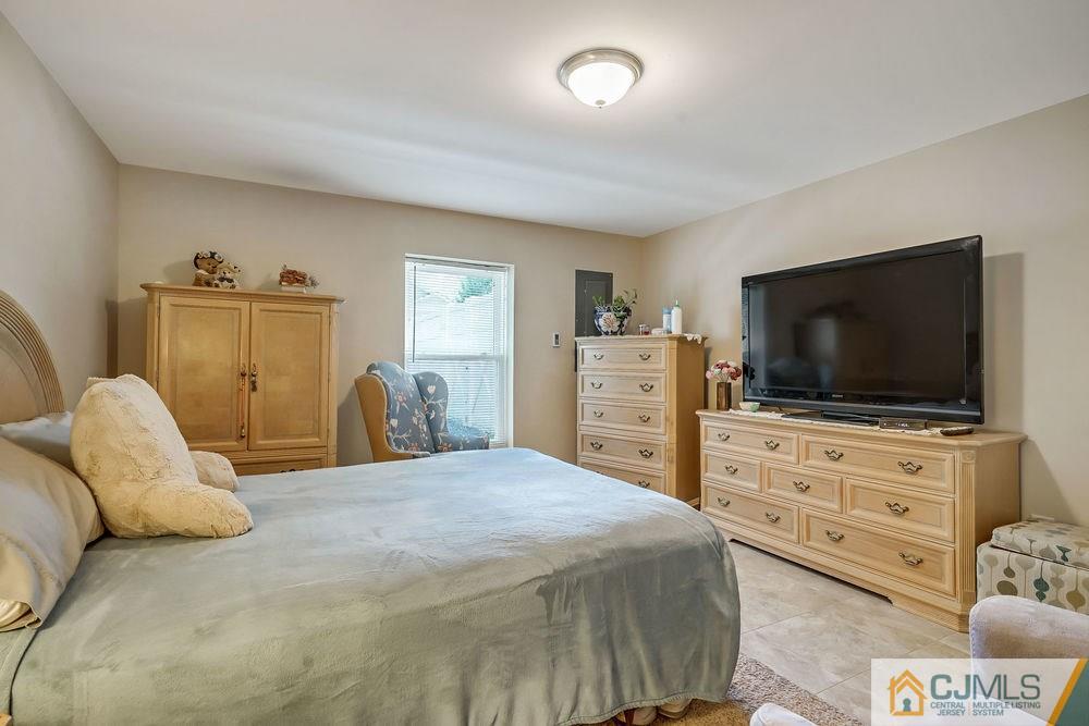 334 Matchaponix Road Old Bridge, NJ 08831 - Photo 13 of 24 a bedroom with a bed and a flat screen television