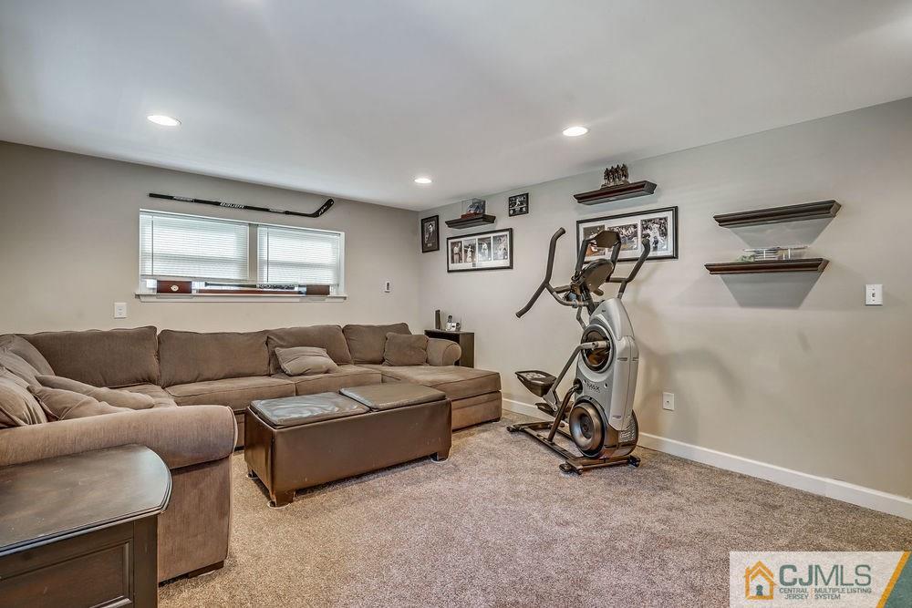 334 Matchaponix Road Old Bridge, NJ 08831 - Photo 17 of 24 a living room with furniture a air conditioner and a window