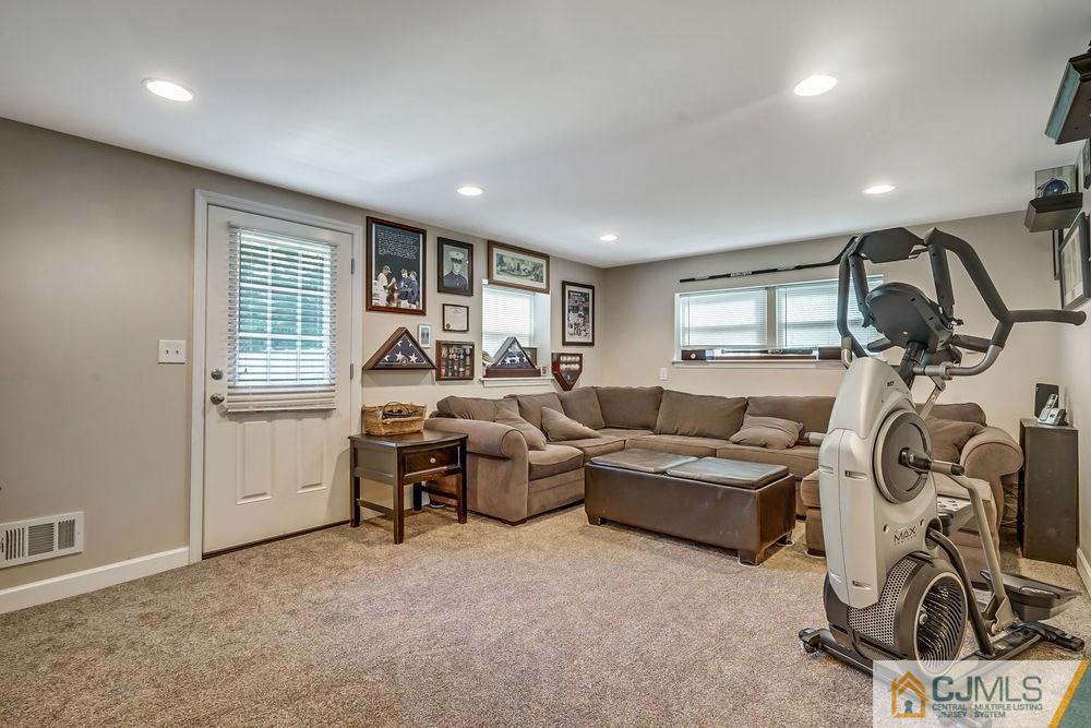 334 Matchaponix Road Old Bridge, NJ 08831 - Photo 19 of 24 a living room with furniture a window and gym equipment