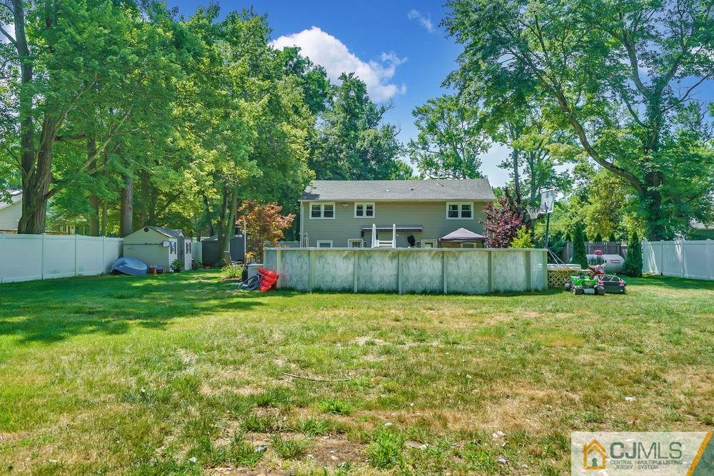 334 Matchaponix Road Old Bridge, NJ 08831 - Photo 23 of 24 a view of a house with a yard and trees
