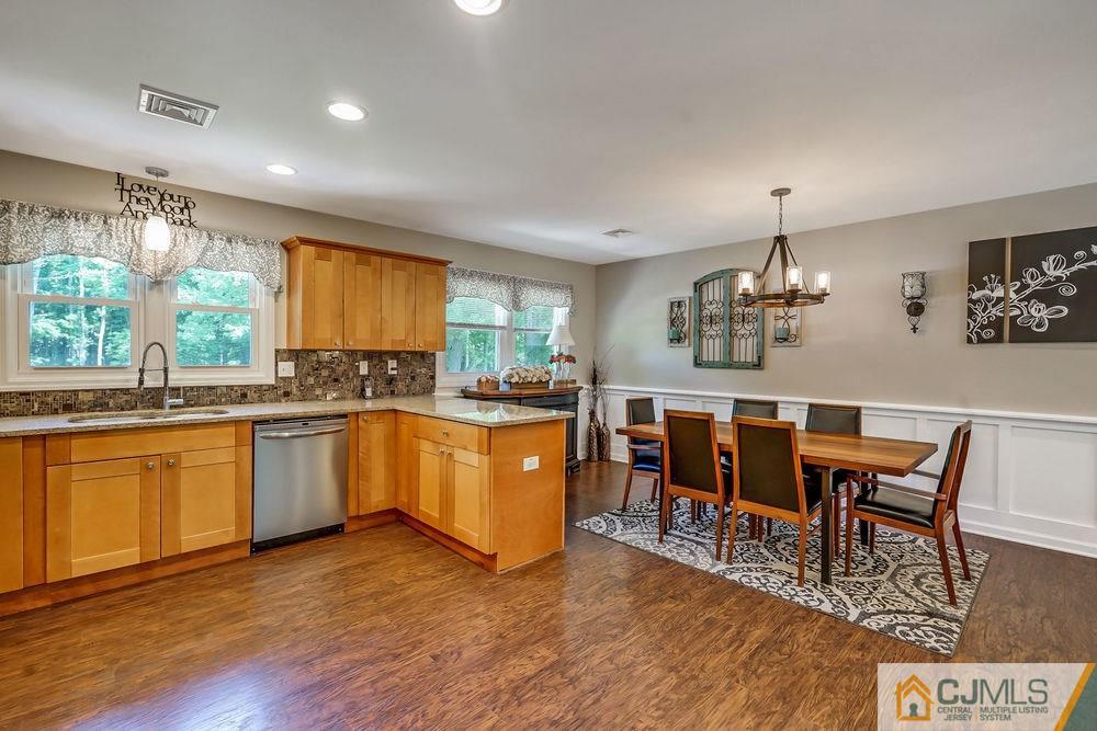 334 Matchaponix Road Old Bridge, NJ 08831 - Photo 7 of 24 a kitchen with stainless steel appliances kitchen island granite countertop a stove a sink a refrigerator dining table and chairs