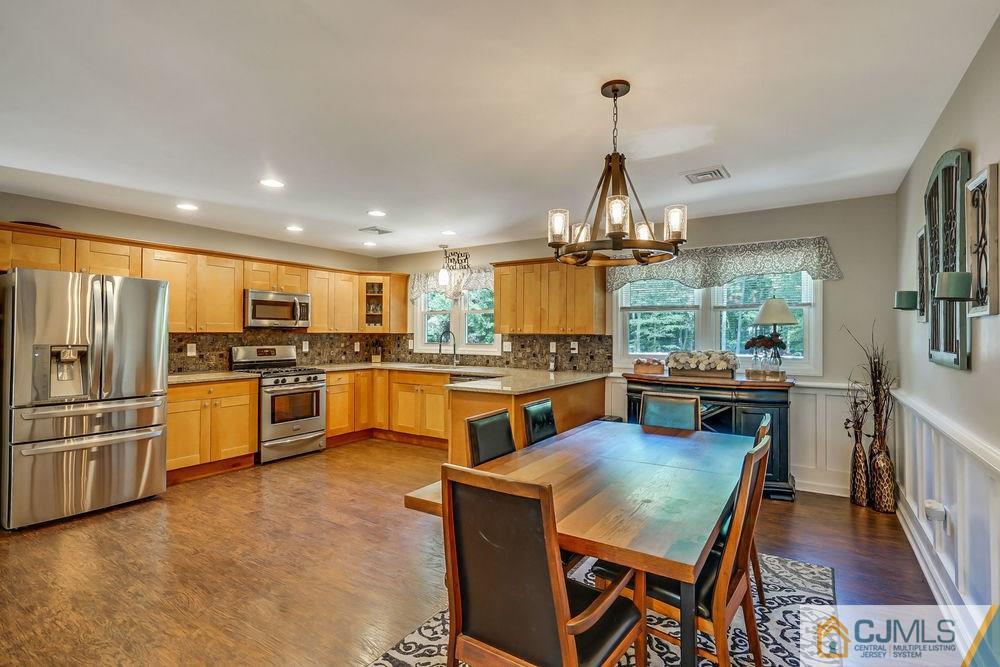 334 Matchaponix Road Old Bridge, NJ 08831 - Photo 8 of 24 a kitchen with stainless steel appliances kitchen island granite countertop a stove and white cabinets