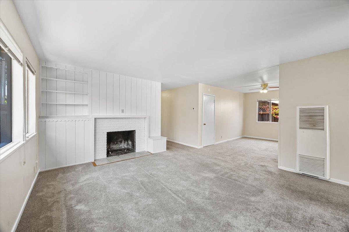 440 Rutherford Avenue Redwood City, CA 94061 - Photo 5 of 19 an empty room with fireplace and windows