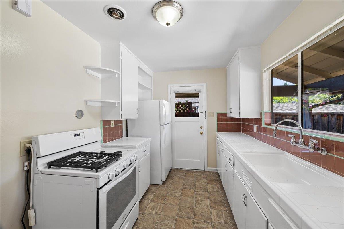 440 Rutherford Avenue Redwood City, CA 94061 - Photo 8 of 19 a kitchen with a stove and a sink