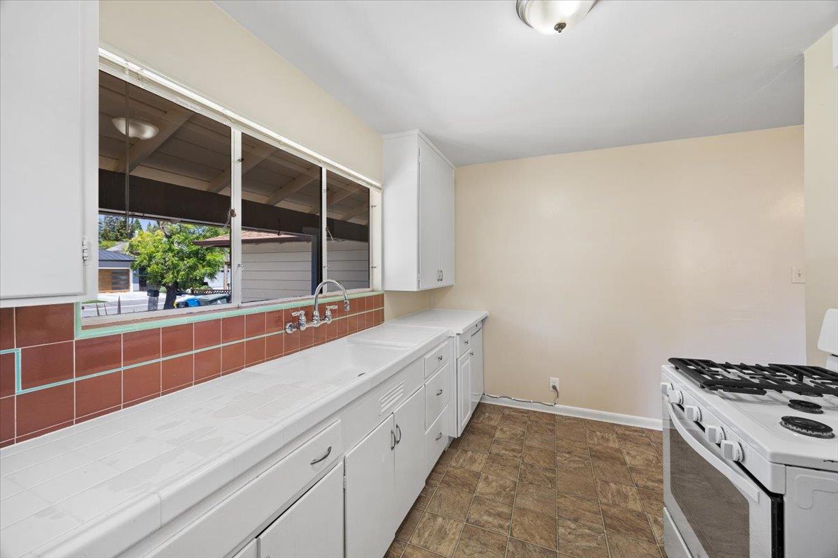 440 Rutherford Avenue Redwood City, CA 94061 - Photo 9 of 19 a view of a kitchen with a sink and dishwasher with wooden floor