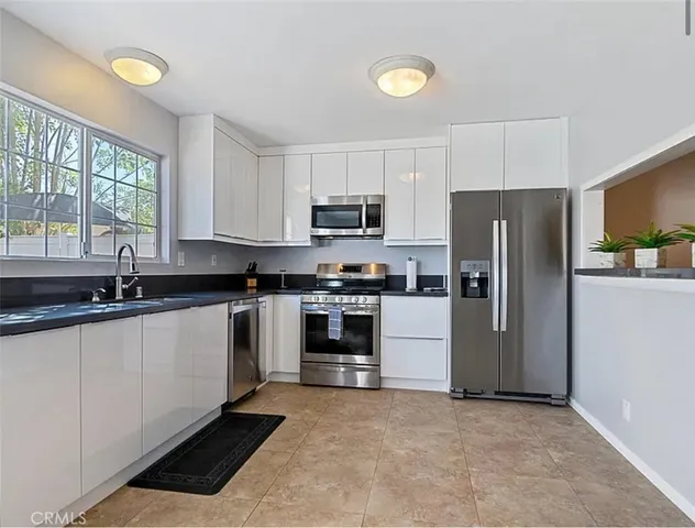 a kitchen with a refrigerator and a sink