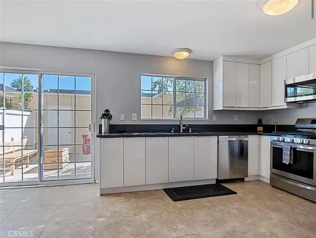 a kitchen with a sink cabinets and window