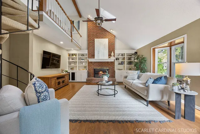 a living room with furniture a fireplace and a flat screen tv