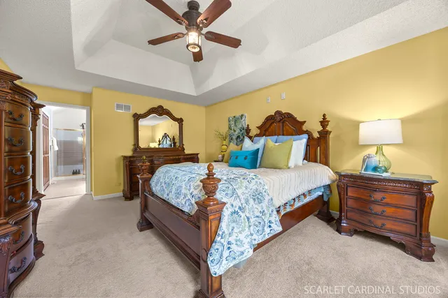 a bedroom with a bed and a chandelier