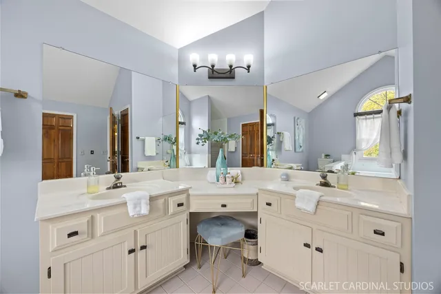 a bathroom with a double vanity sink and a mirror