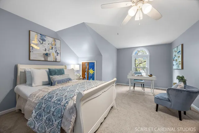a bedroom with a large bed and a chandelier