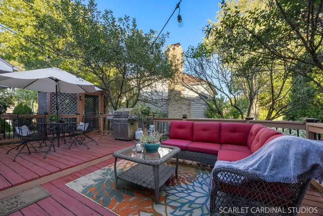 a view of patio with couches table and chairs under an umbrella