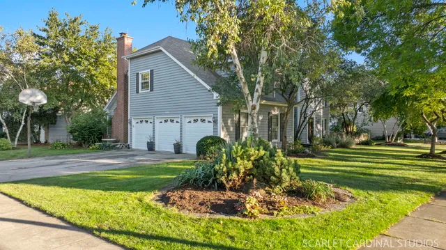 a front view of a house with a yard table and chairs