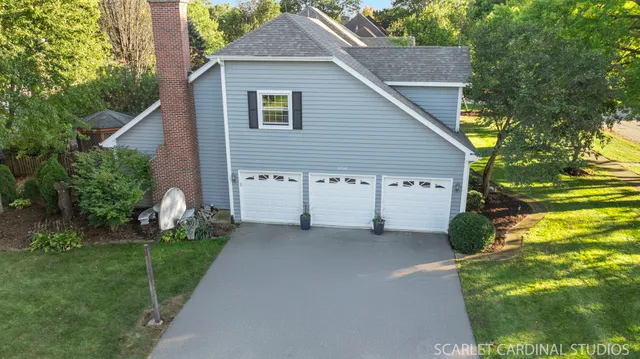 a view of a house with a yard and potted plants