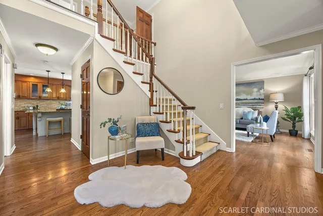 a living room with wooden floor and furniture