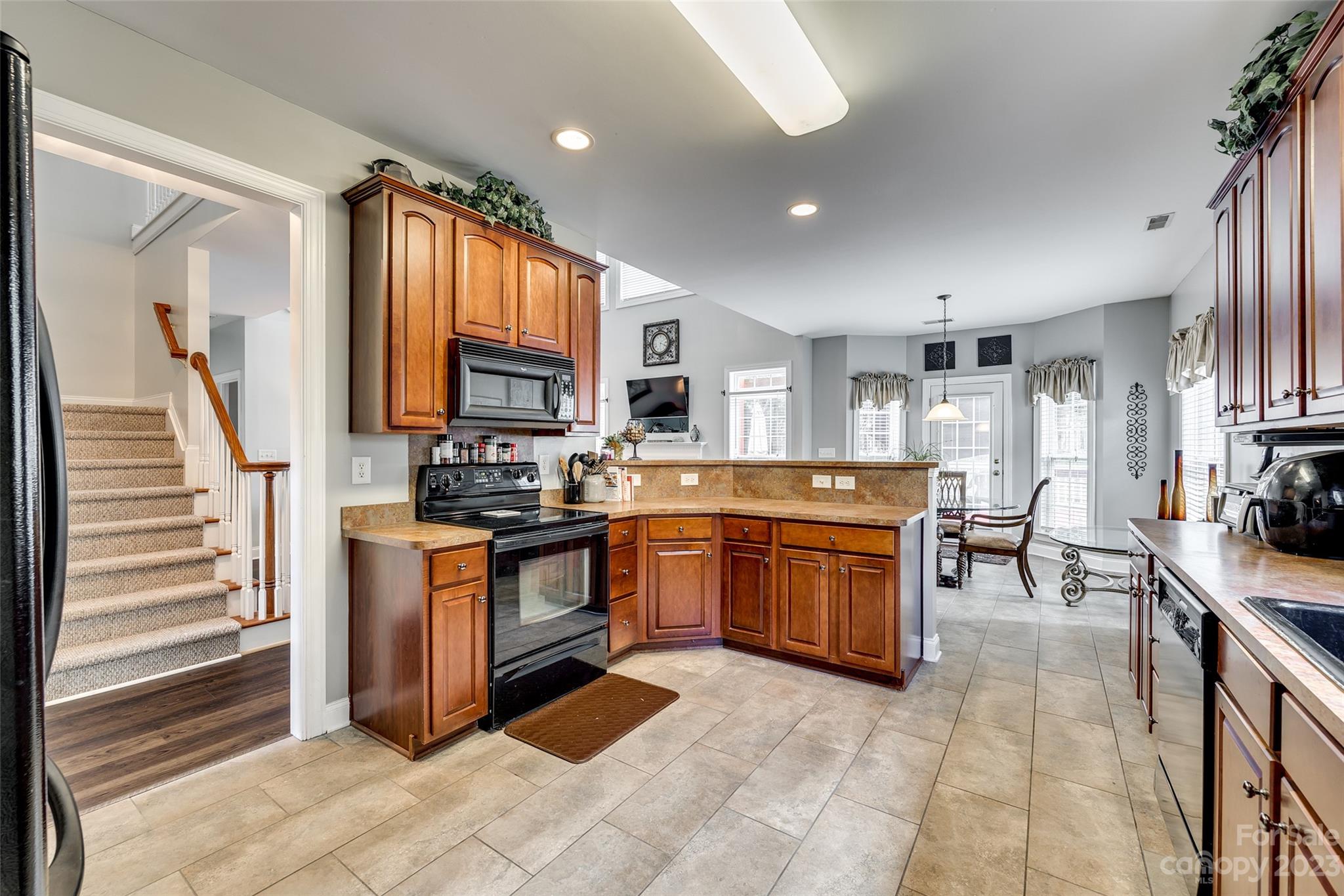 5540 Alexandrite Way Fort Mill, SC 29708 - Photo 16 of 46 a kitchen with stainless steel appliances granite countertop a stove top oven a sink dishwasher and a refrigerator