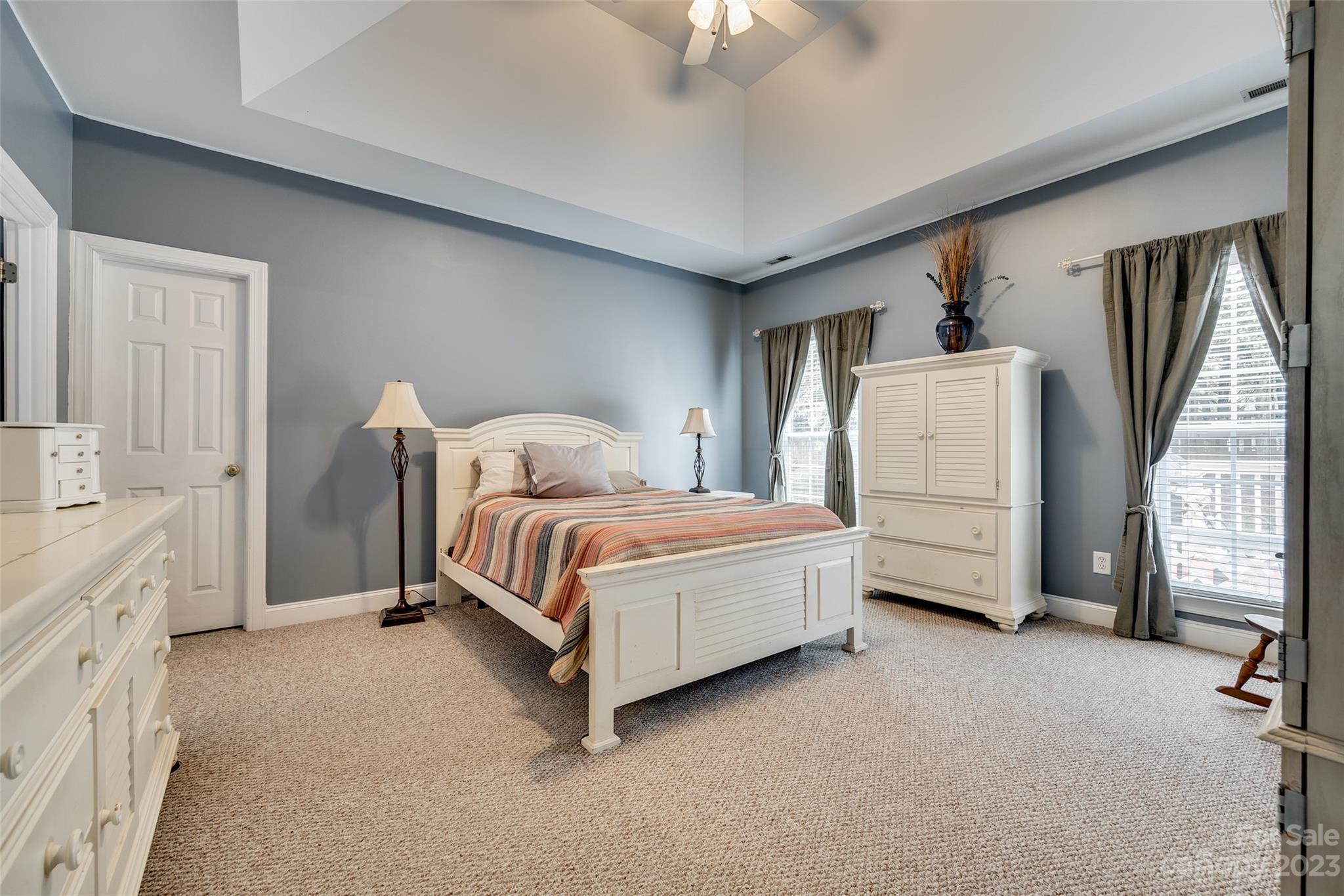 5540 Alexandrite Way Fort Mill, SC 29708 - Photo 18 of 46 a bedroom with a bed closet and a flat tv screen