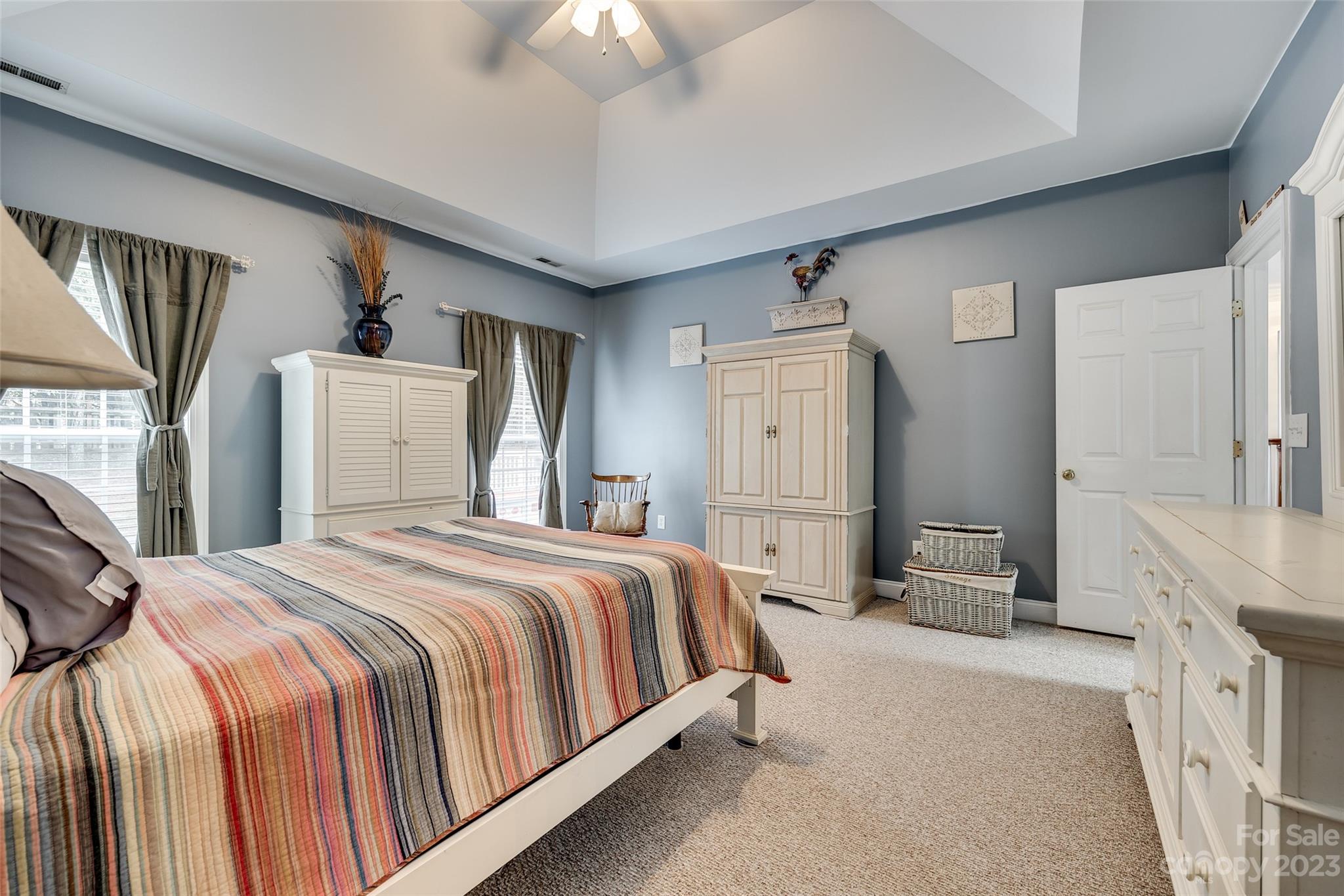 5540 Alexandrite Way Fort Mill, SC 29708 - Photo 19 of 46 a bedroom with a large bed a flat tv screen and dresser