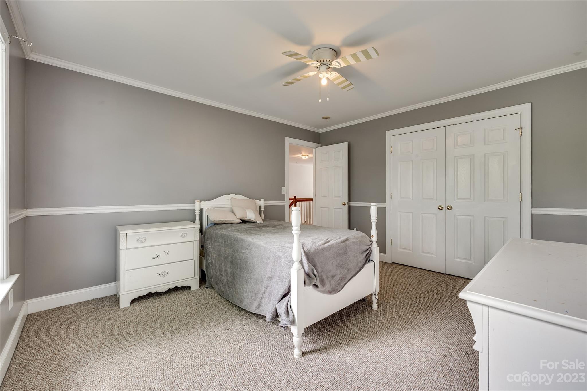 5540 Alexandrite Way Fort Mill, SC 29708 - Photo 32 of 46 a bed room with a bed and a chandelier