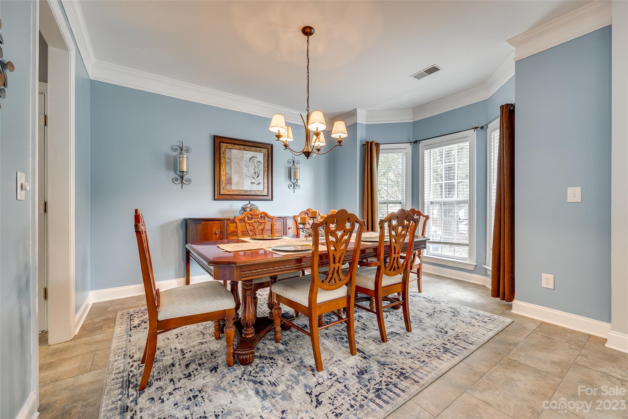 5540 Alexandrite Way Fort Mill, SC 29708 - Photo 7 of 46 a dining room with furniture a chandelier and wooden floor