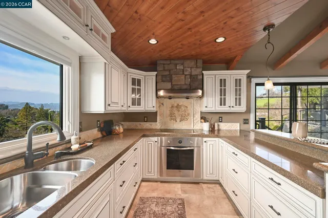 a large kitchen with a sink and cabinets