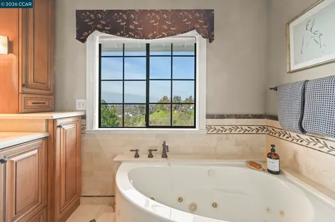 a bathroom with a bathtub and a window