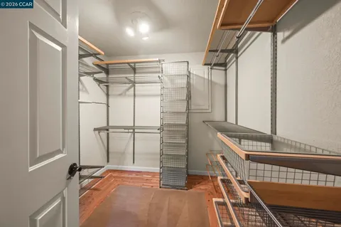 a view of walk in closet with empty racks