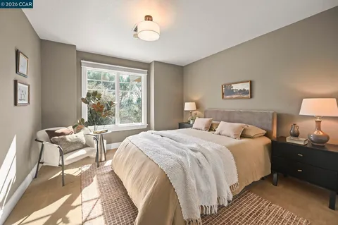 a bedroom with a bed and a lamp next to a window