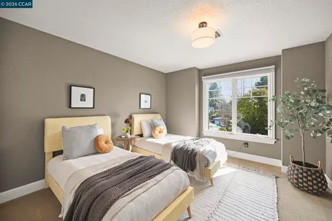 a bedroom with beds and a large window