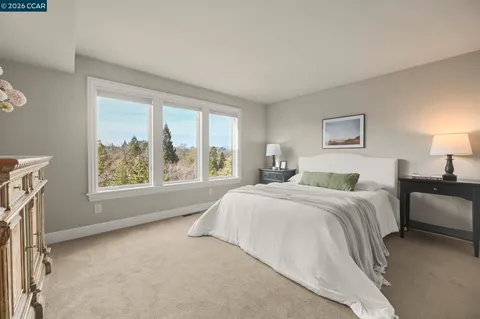 a spacious bedroom with a large bed and a window