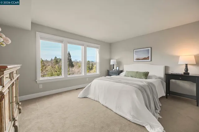 a spacious bedroom with a large bed and a window