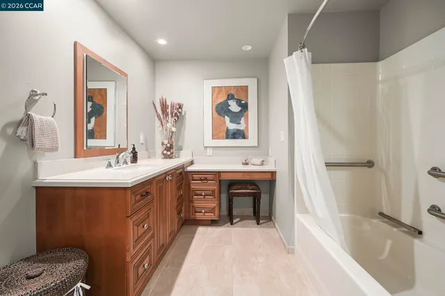 a spacious bathroom with a tub sink and mirror