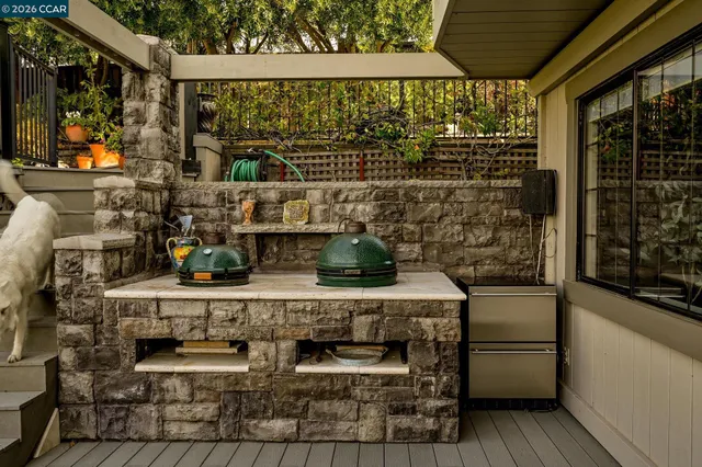 a view of a chairs and table on the roof deck