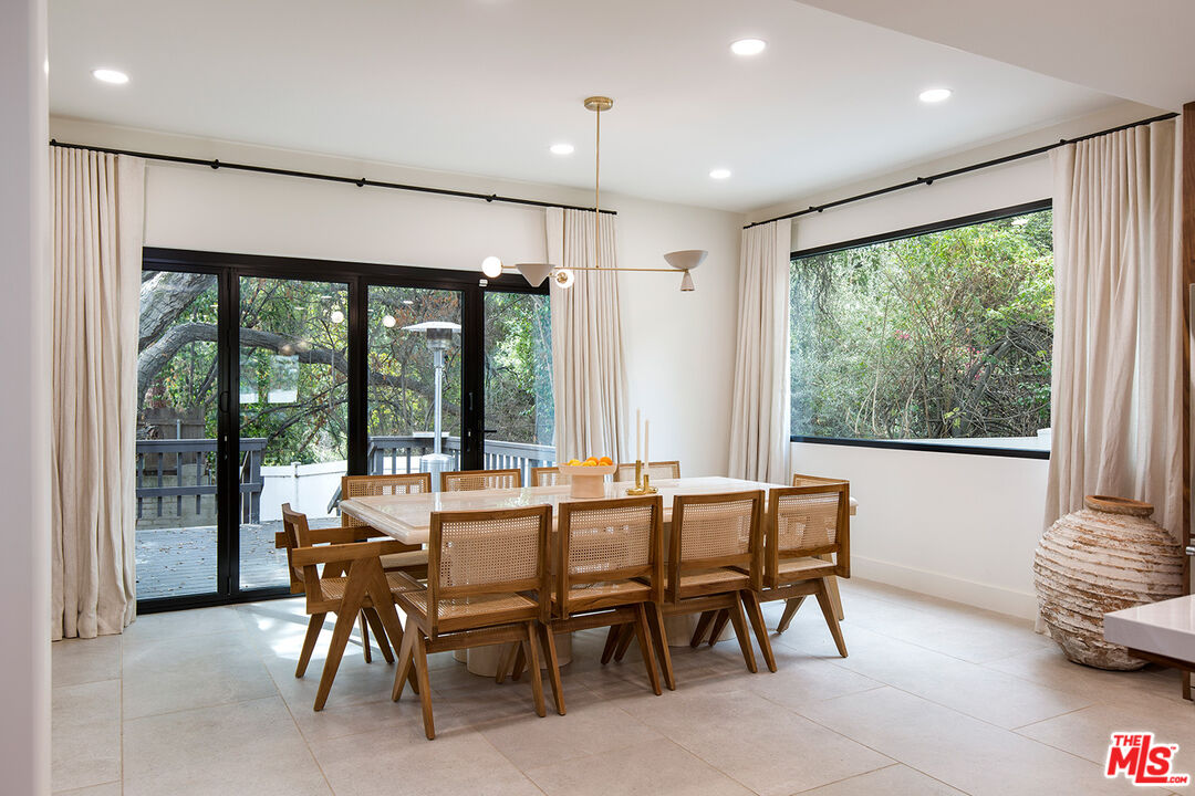 1700 Old Grove Road Pasadena, CA 91107 - Photo 12 of 33 a dining room with furniture large windows and a chandelier