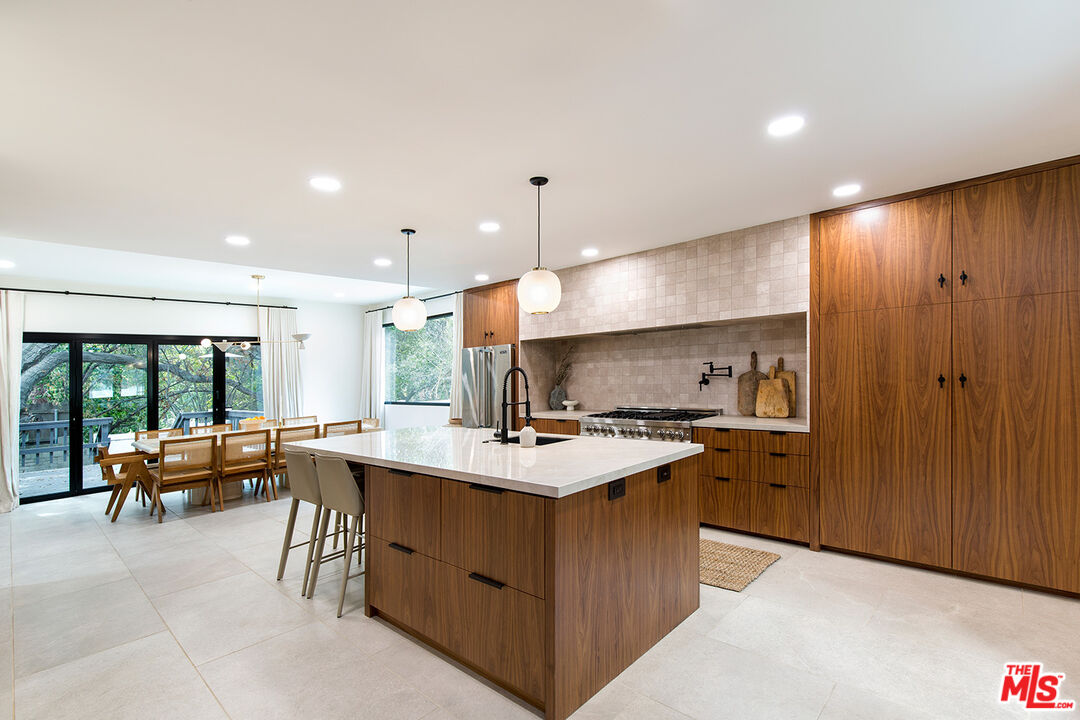 1700 Old Grove Road Pasadena, CA 91107 - Photo 17 of 33 a kitchen with stainless steel appliances a stove a sink a oven a dining table and chairs