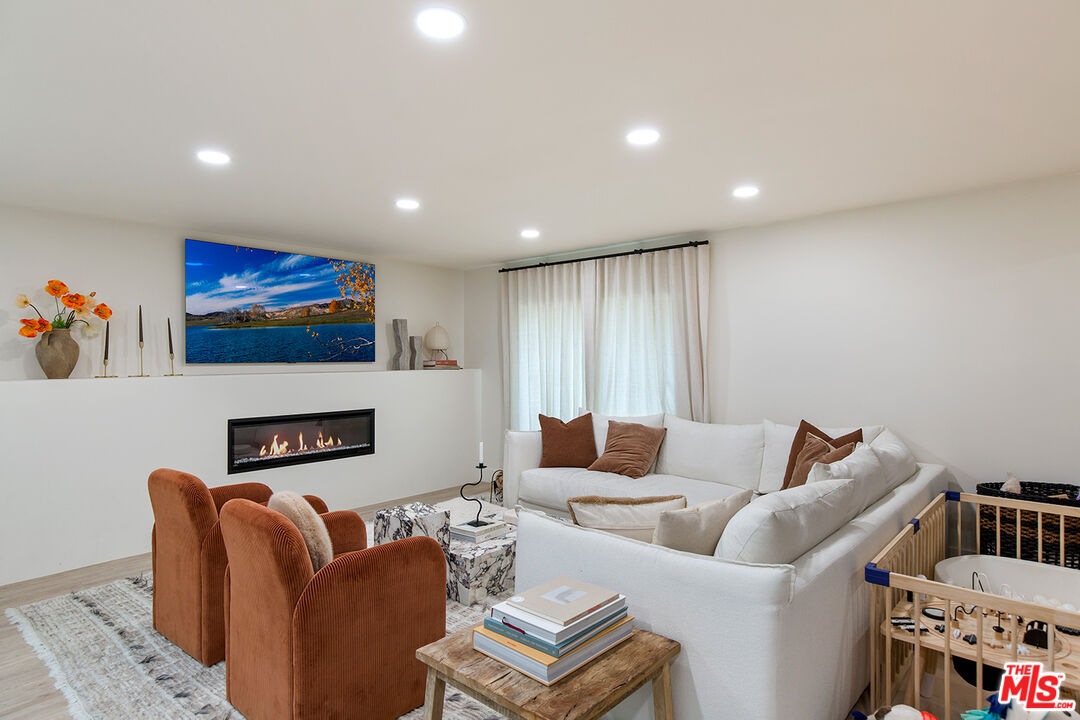 1700 Old Grove Road Pasadena, CA 91107 - Photo 8 of 33 a living room with furniture a fireplace and a flat screen tv