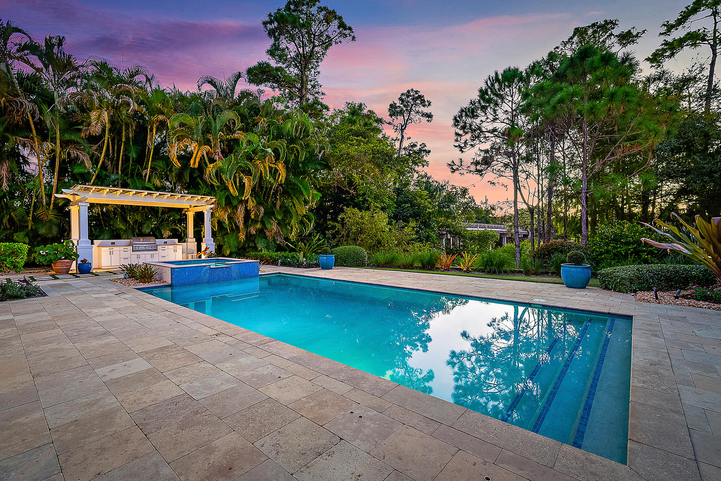 18706 Southeast St Augustine Way Jupiter, FL 33469 - Photo 15 of 74 a view of swimming pool with seating area and trees in the background