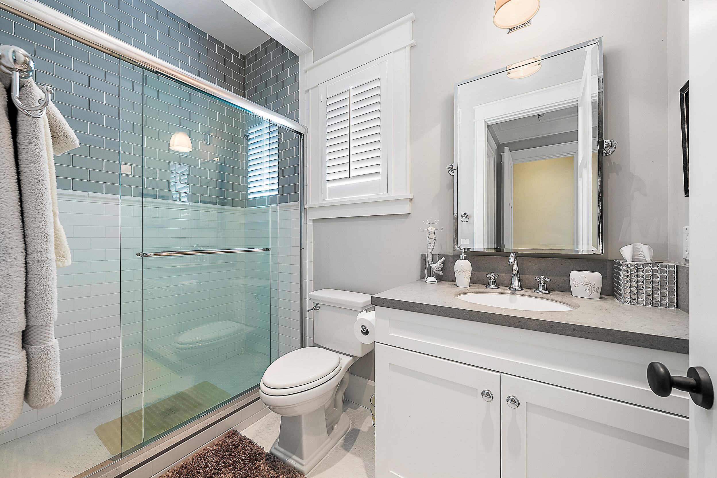 18706 Southeast St Augustine Way Jupiter, FL 33469 - Photo 56 of 74 a bathroom with a granite countertop toilet sink and mirror