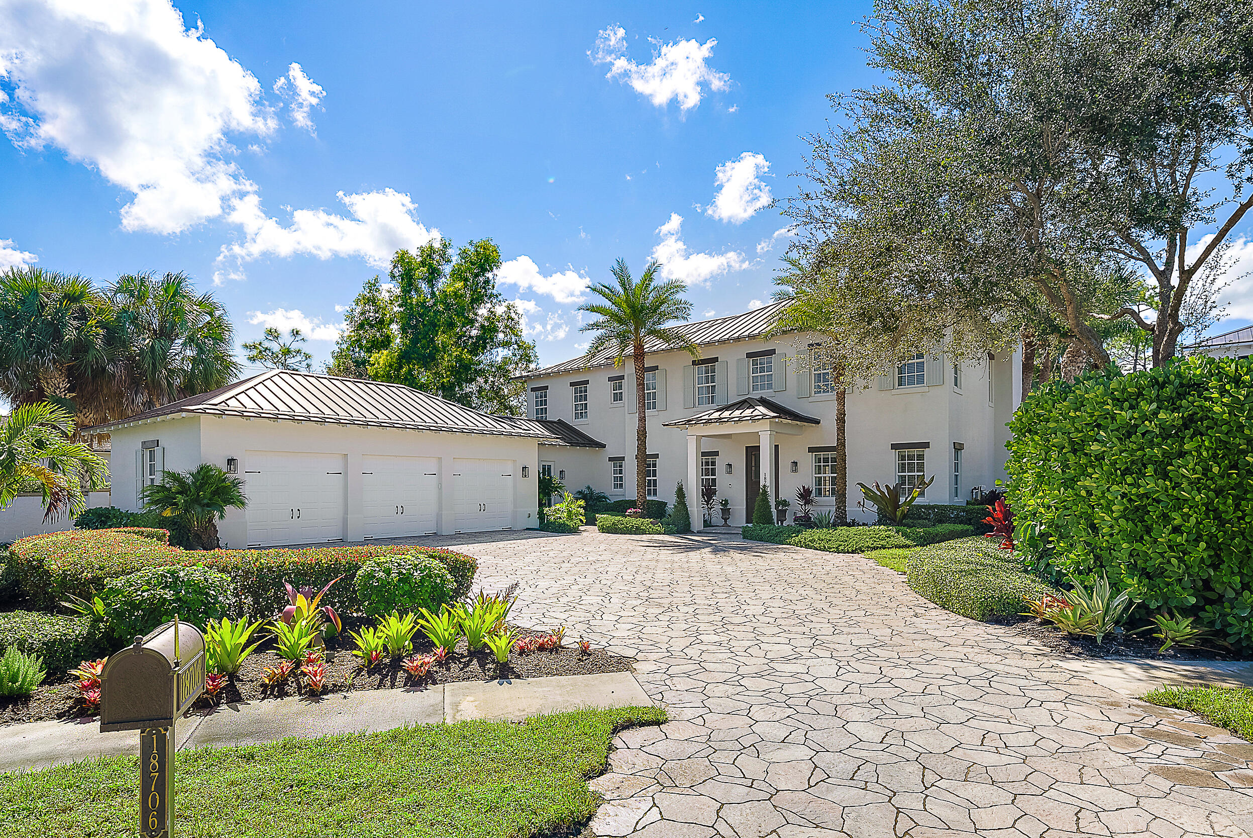 18706 Southeast St Augustine Way Jupiter, FL 33469 - Photo 65 of 74 a front view of a house with a yard and a garden