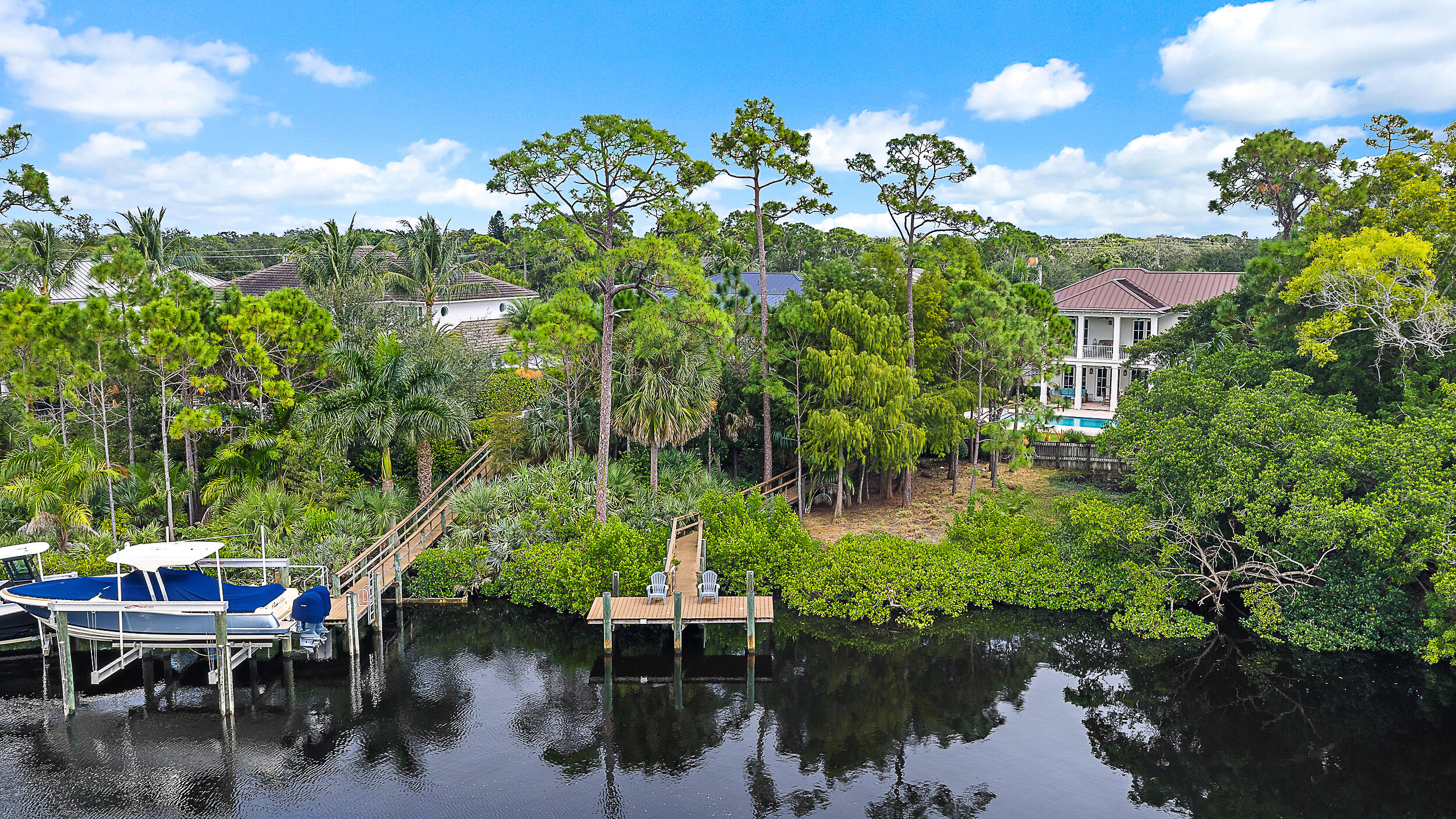 18706 Southeast St Augustine Way Jupiter, FL 33469 - Photo 74 of 74 a view of a lake with a table and chairs