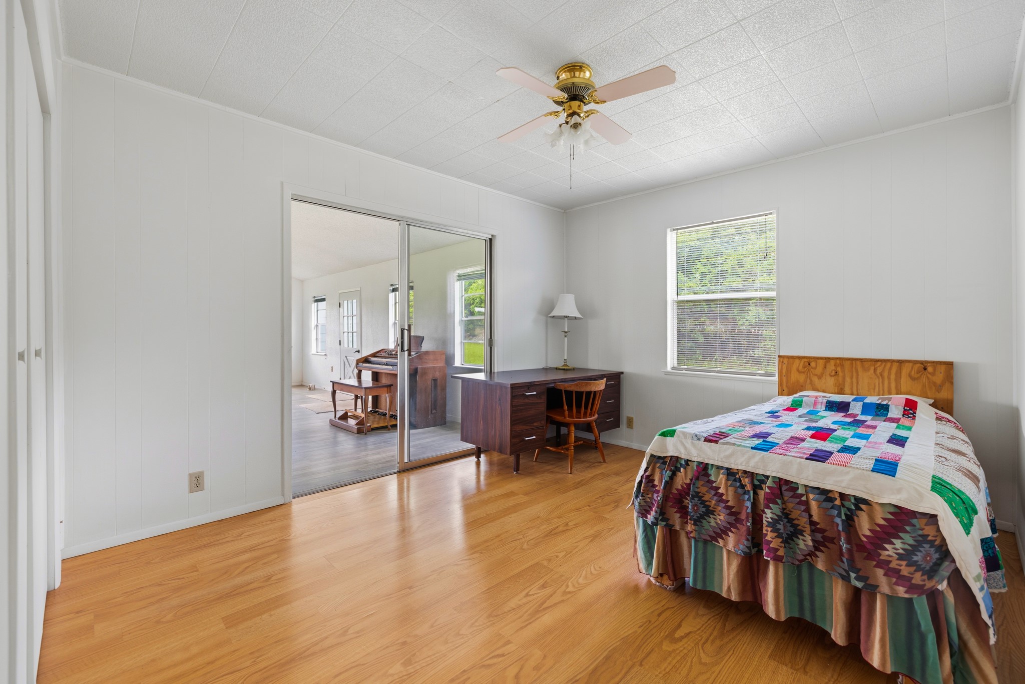 341 River View Road Fredericksburg, TX 78624 - Photo 18 of 40 Gleaming hardwood floors and a sliding glass door define this versatile bedroom space.