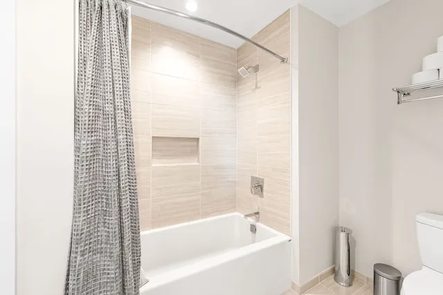 a bathroom with a bathtub and shower